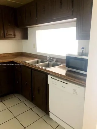 a kitchen with a sink and a window
