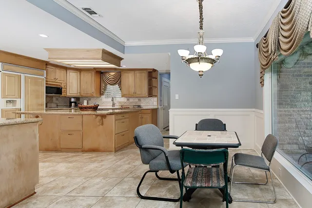 a kitchen with a cabinets a counter space dining table and a sink