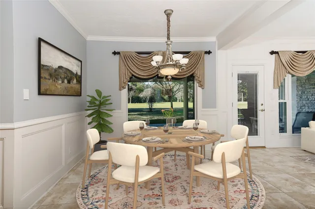a dining room with furniture a rug and a chandelier