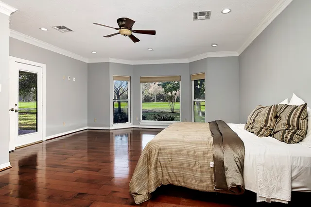 a bedroom with a bed and a large window