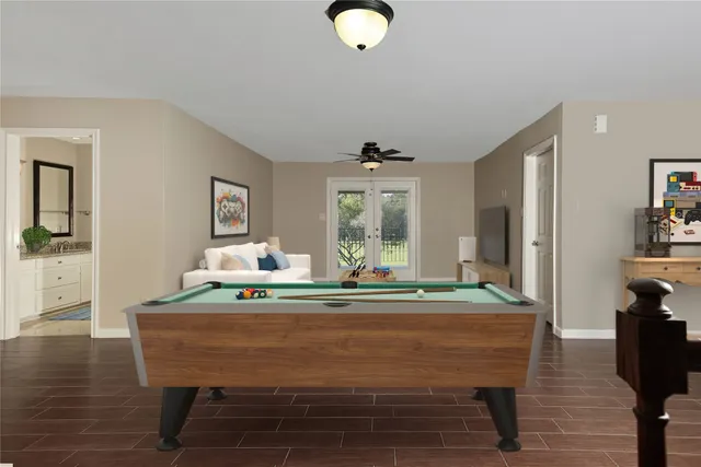 a room with pool table and windows