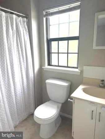 a bathroom with a toilet sink and a shower