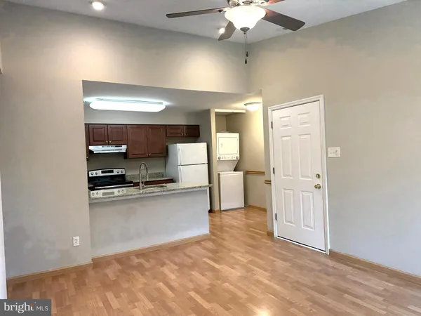 a large kitchen with stainless steel appliances a refrigerator and a stove top oven