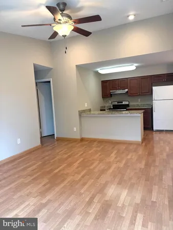 a view of a kitchen with a sink and a ceiling fan