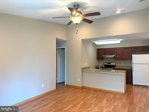 a kitchen with stainless steel appliances a stove a refrigerator and a cabinets
