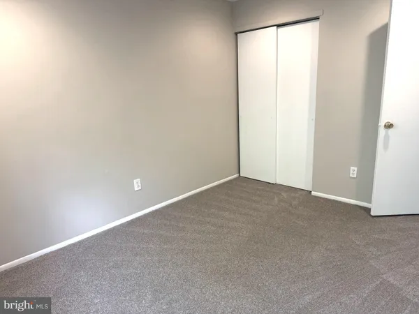 a view of an empty room and a window