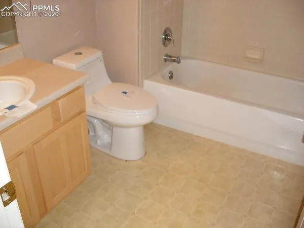 a white bath tub sitting next to a white toilet
