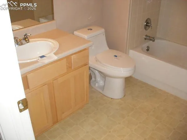 a bathroom with a sink a toilet and bathtub