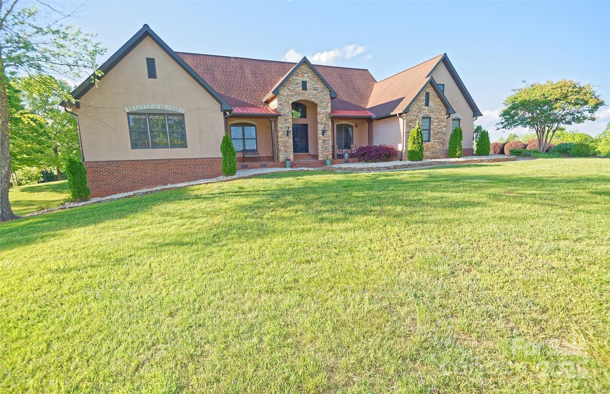 1250 Mountain Creek Road Rutherfordton, NC 28139 - Photo 1 of 48 a front view of a house with a yard and garage