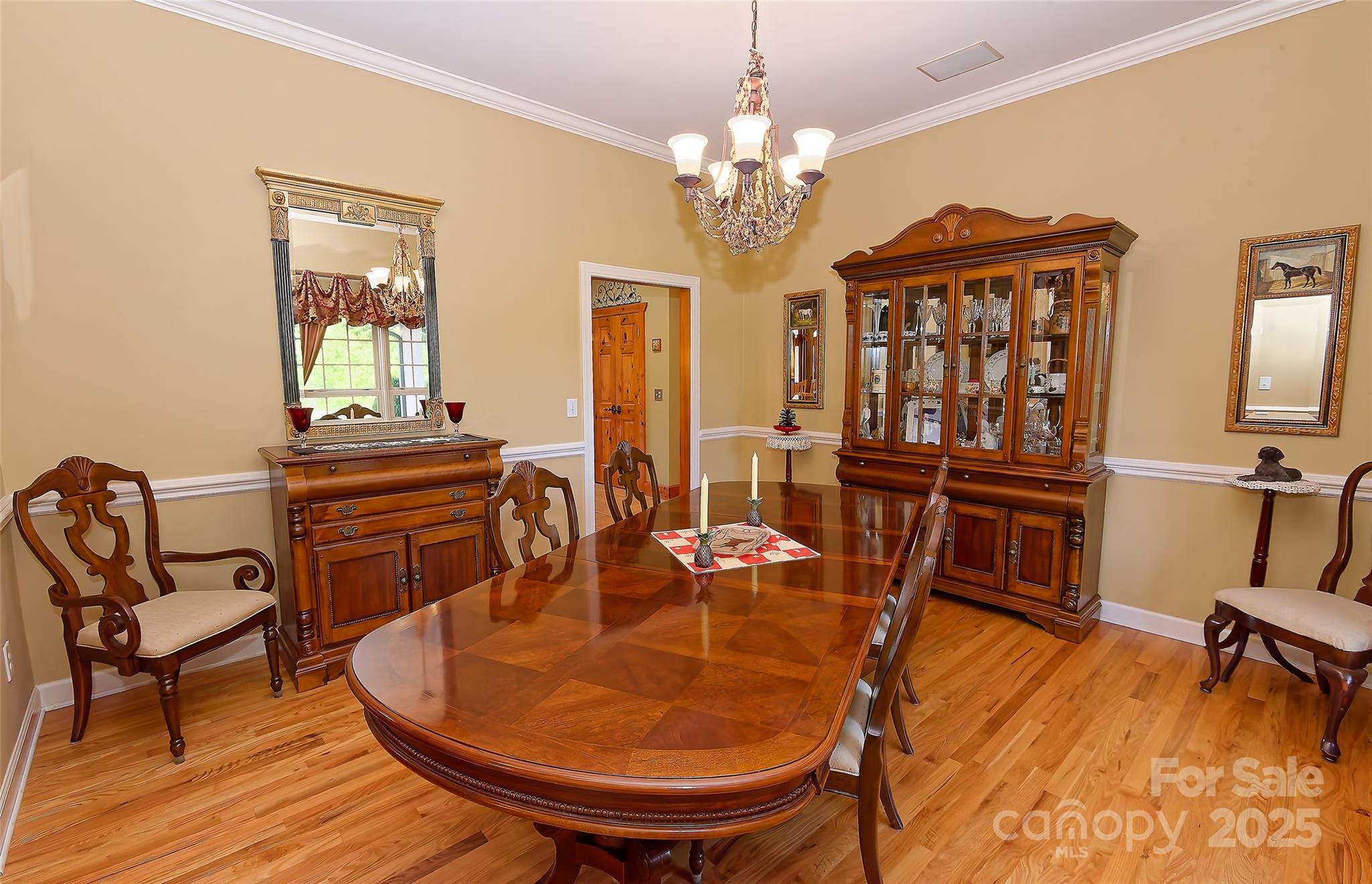 1250 Mountain Creek Road Rutherfordton, NC 28139 - Photo 16 of 48 a dining room with furniture a chandelier and wooden floor