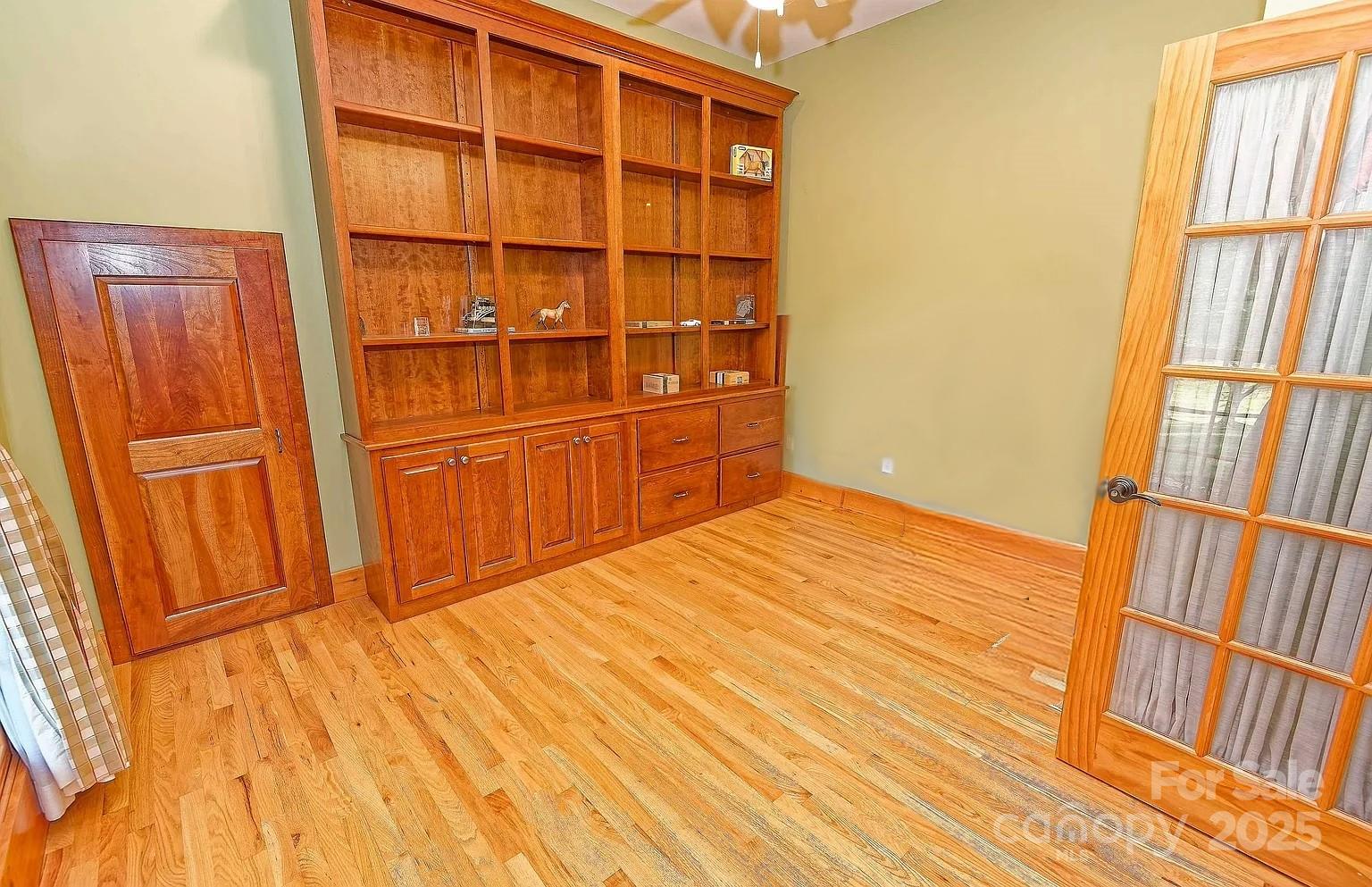 1250 Mountain Creek Road Rutherfordton, NC 28139 - Photo 18 of 48 a view of a bedroom with wooden floor and door