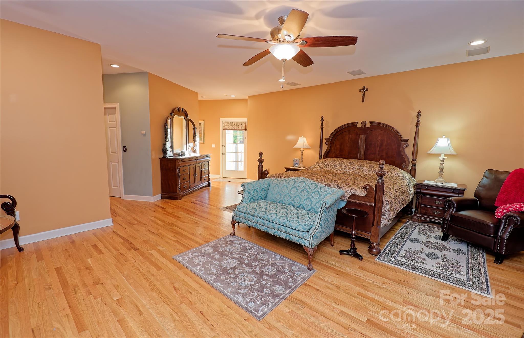 1250 Mountain Creek Road Rutherfordton, NC 28139 - Photo 20 of 48 a bedroom with a bed a chandelier and dresser