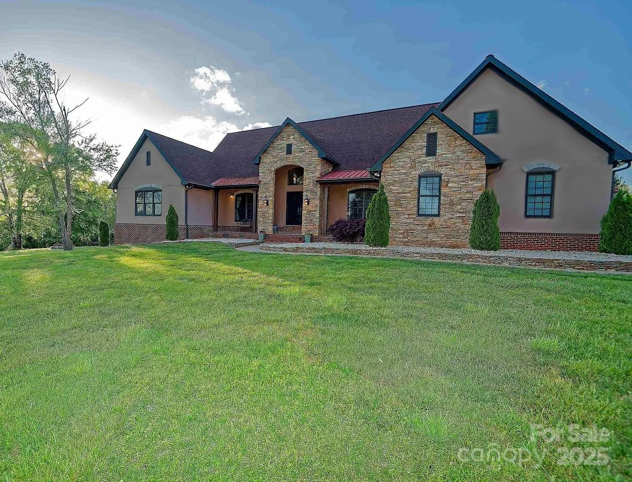 1250 Mountain Creek Road Rutherfordton, NC 28139 - Photo 2 of 48 a front view of a house with a yard and garage