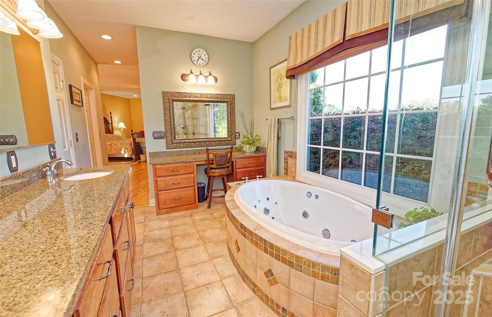 1250 Mountain Creek Road Rutherfordton, NC 28139 - Photo 23 of 48 a spacious bathroom with a tub a double vanity sink and a large mirror