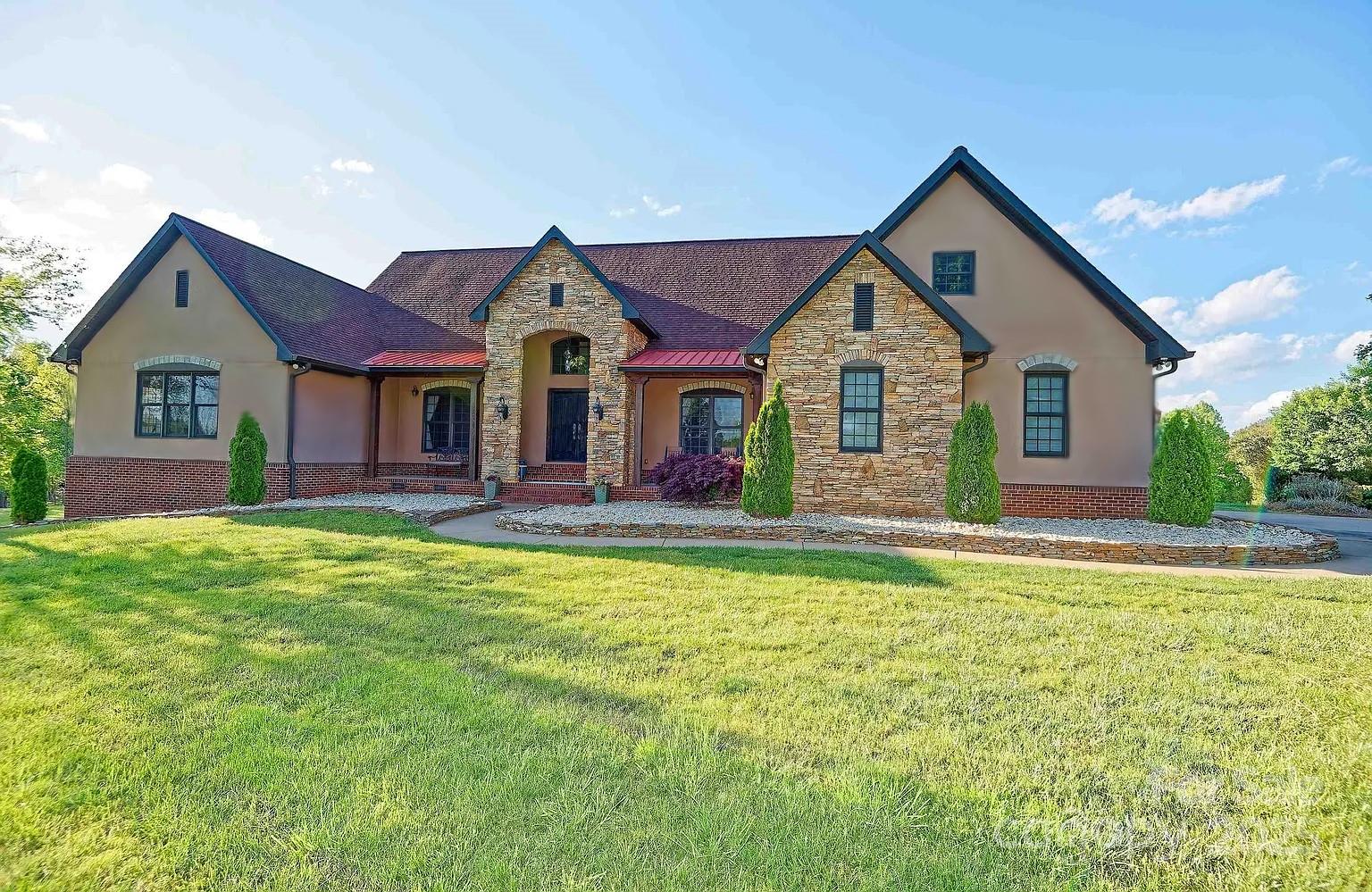 1250 Mountain Creek Road Rutherfordton, NC 28139 - Photo 5 of 48 a front view of a house with a yard and garage
