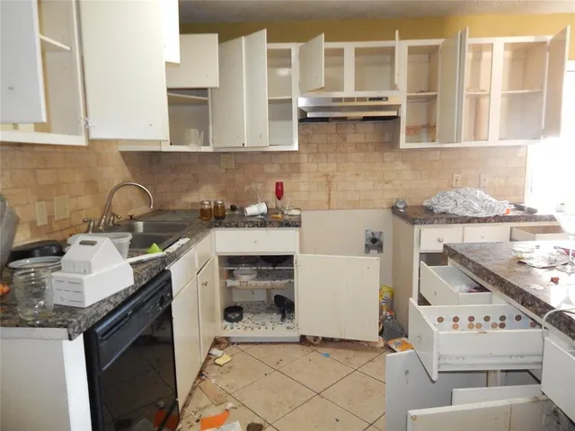 a living room with furniture a fireplace and a floor to ceiling window