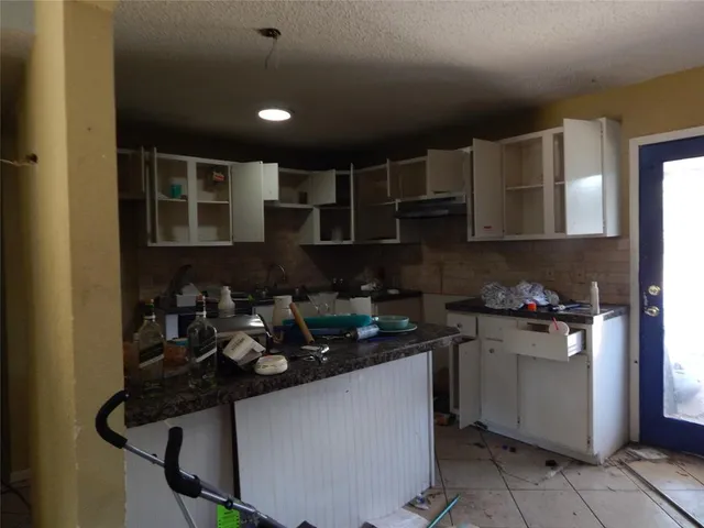 a kitchen with a sink dishwasher and a stove top oven