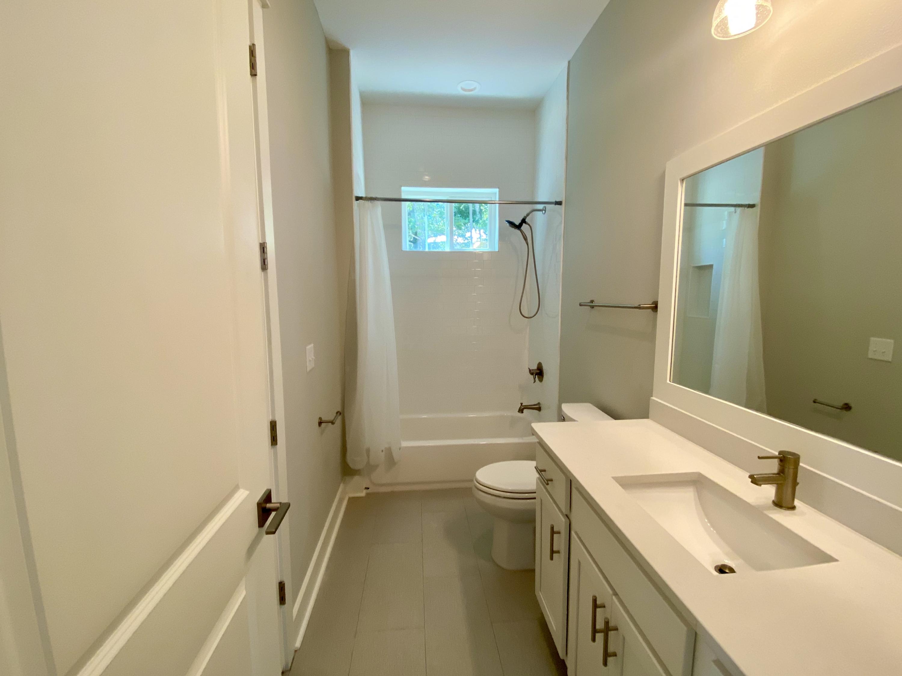 103 Rearden Way Santa Rosa Beach, FL 32459 - Photo 23 of 31 a bathroom with a sink and mirror with toilet