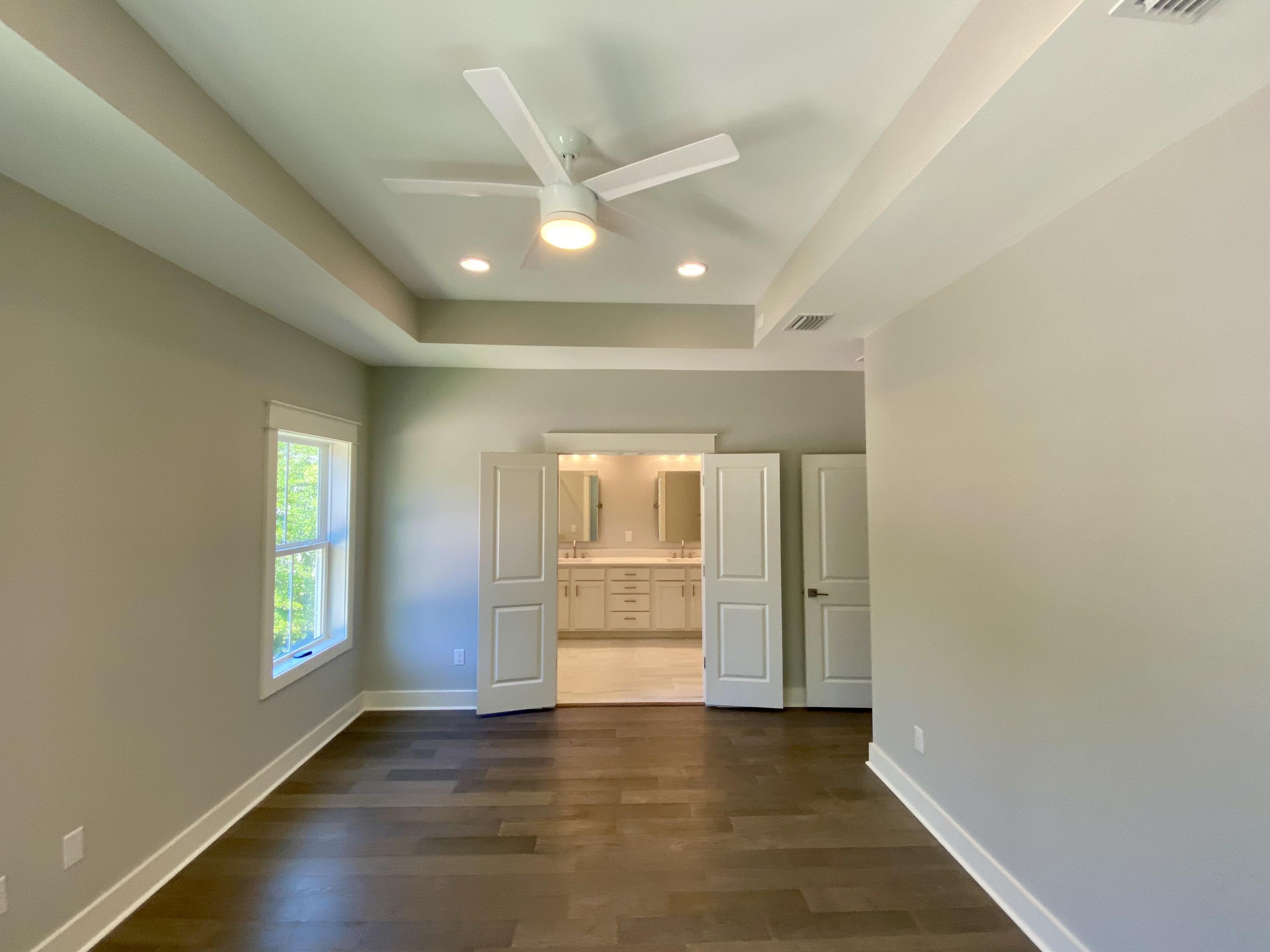 103 Rearden Way Santa Rosa Beach, FL 32459 - Photo 26 of 31 an empty room with wooden floor and windows