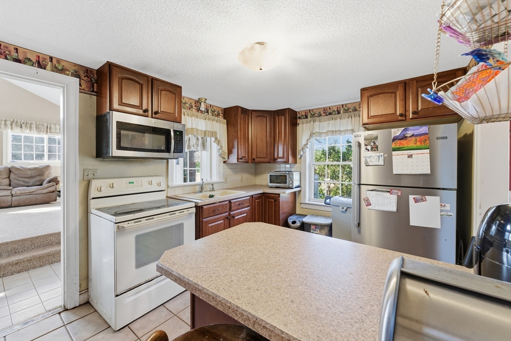 289 Morgan Street South Hadley, MA 01075 - Photo 13 of 42 a kitchen with stainless steel appliances a stove refrigerator sink and microwave