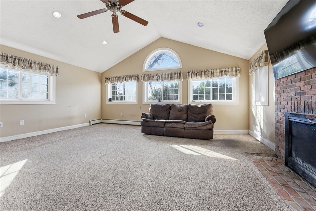 289 Morgan Street South Hadley, MA 01075 - Photo 15 of 42 a living room with furniture a fireplace and a flat screen tv