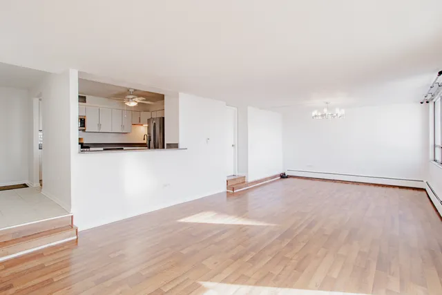 a view of a room with wooden floor and cabinet