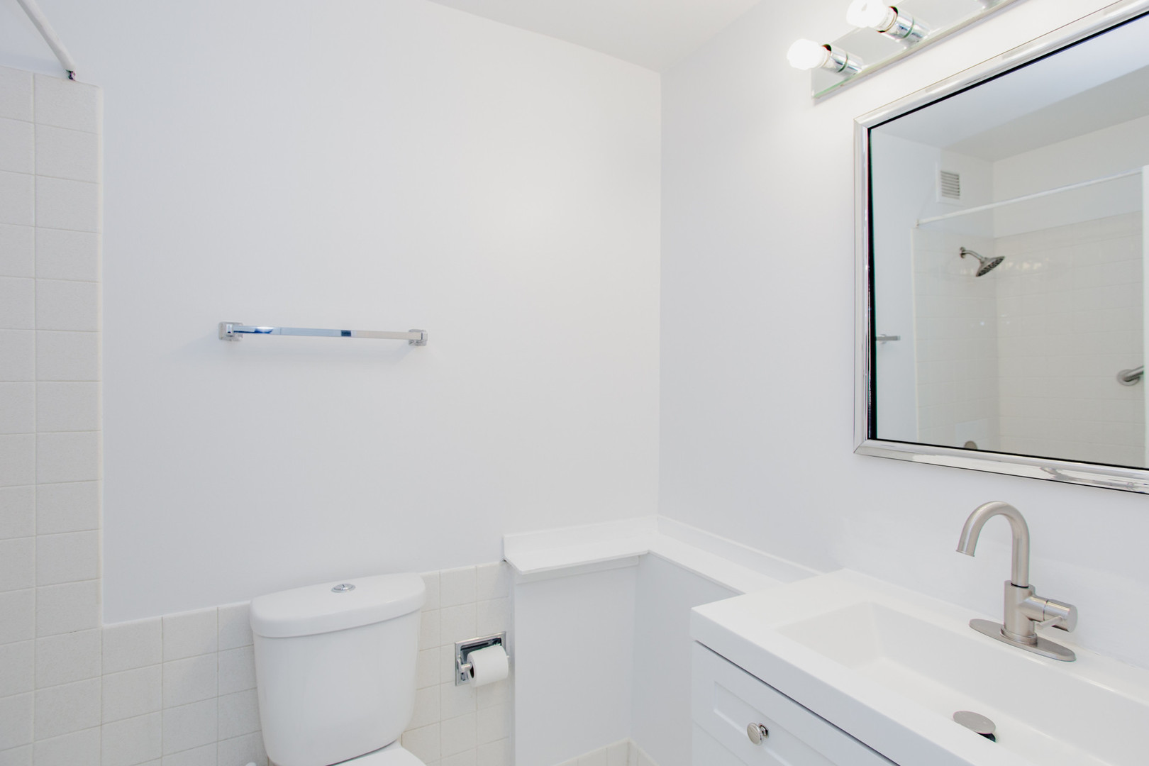 8801 West Golf Road, Unit 6B Niles, IL 60714 - Photo 10 of 13 a bathroom with a sink a toilet and mirror