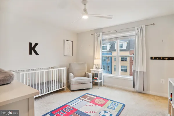 a bedroom with a bed and large windows