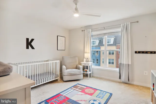 a bedroom with a bed and large windows