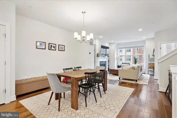 a large kitchen with lots of counter space a sink dining table and chairs