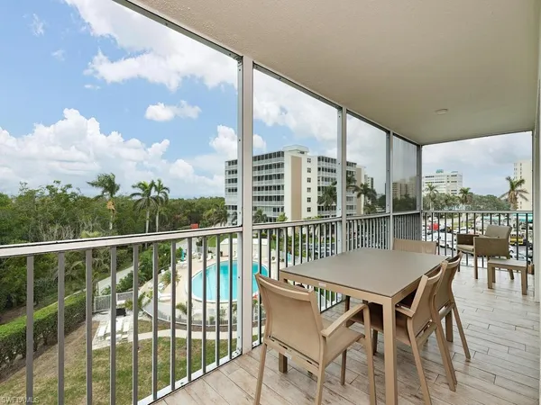 a view of a balcony with table and chairs