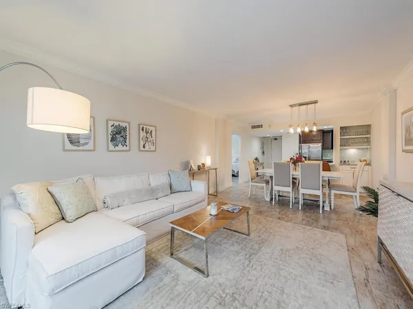 a living room with furniture a flat screen tv and a floor to ceiling window