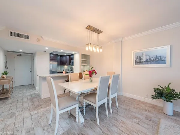 a large bedroom with a bed and a wooden floor