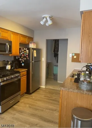 a kitchen with stainless steel appliances granite countertop a refrigerator stove and sink
