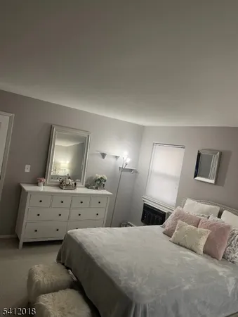 a bedroom with a bed and lamp