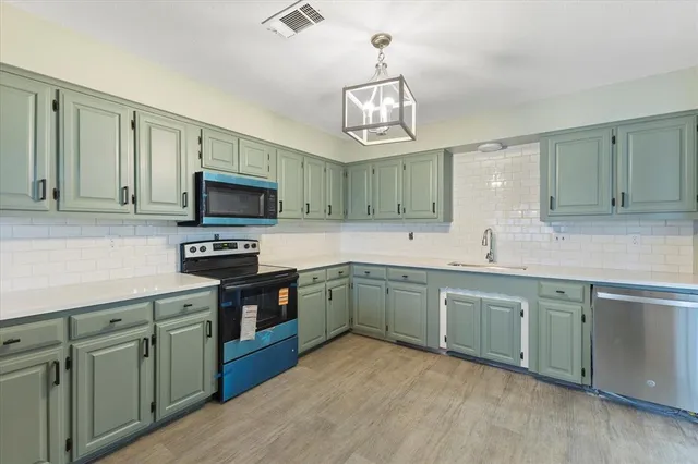 a kitchen with stainless steel appliances granite countertop a sink and stove top oven