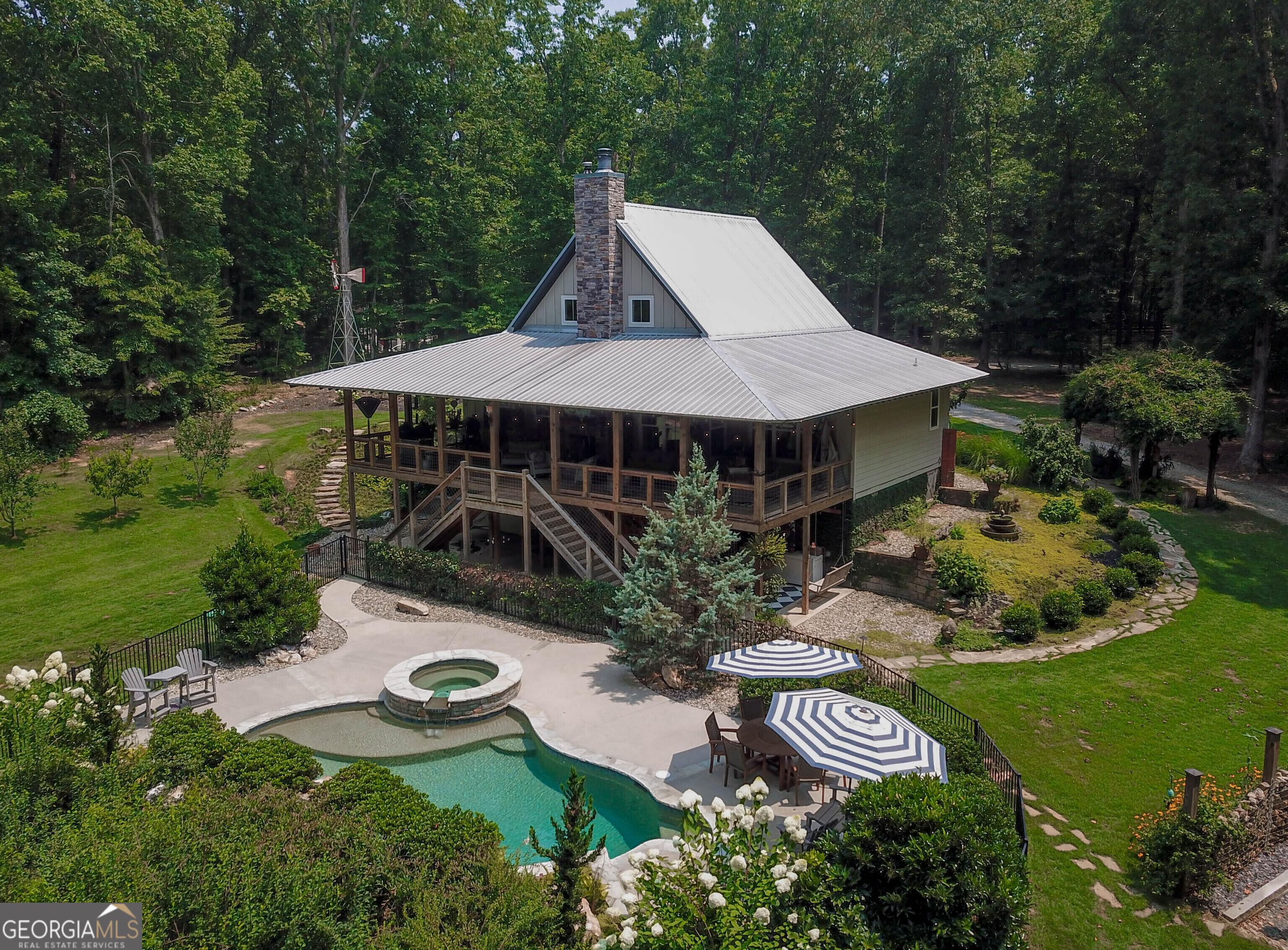 an aerial view of a house with garden space and street view