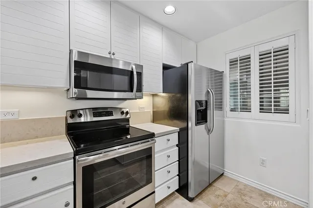 a kitchen with a stove microwave and refrigerator