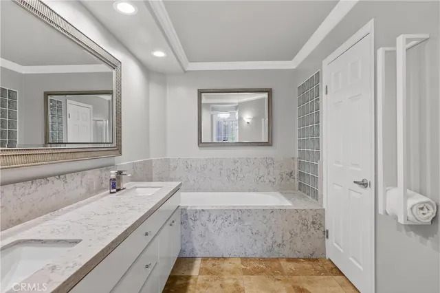 a bathroom with a granite countertop bathtub shower sink and mirror