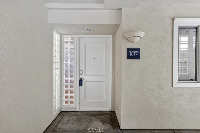 a view of a hallway with wooden floor and a window