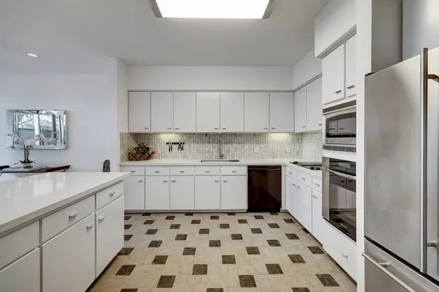 a kitchen with granite countertop appliances a sink and a refrigerator