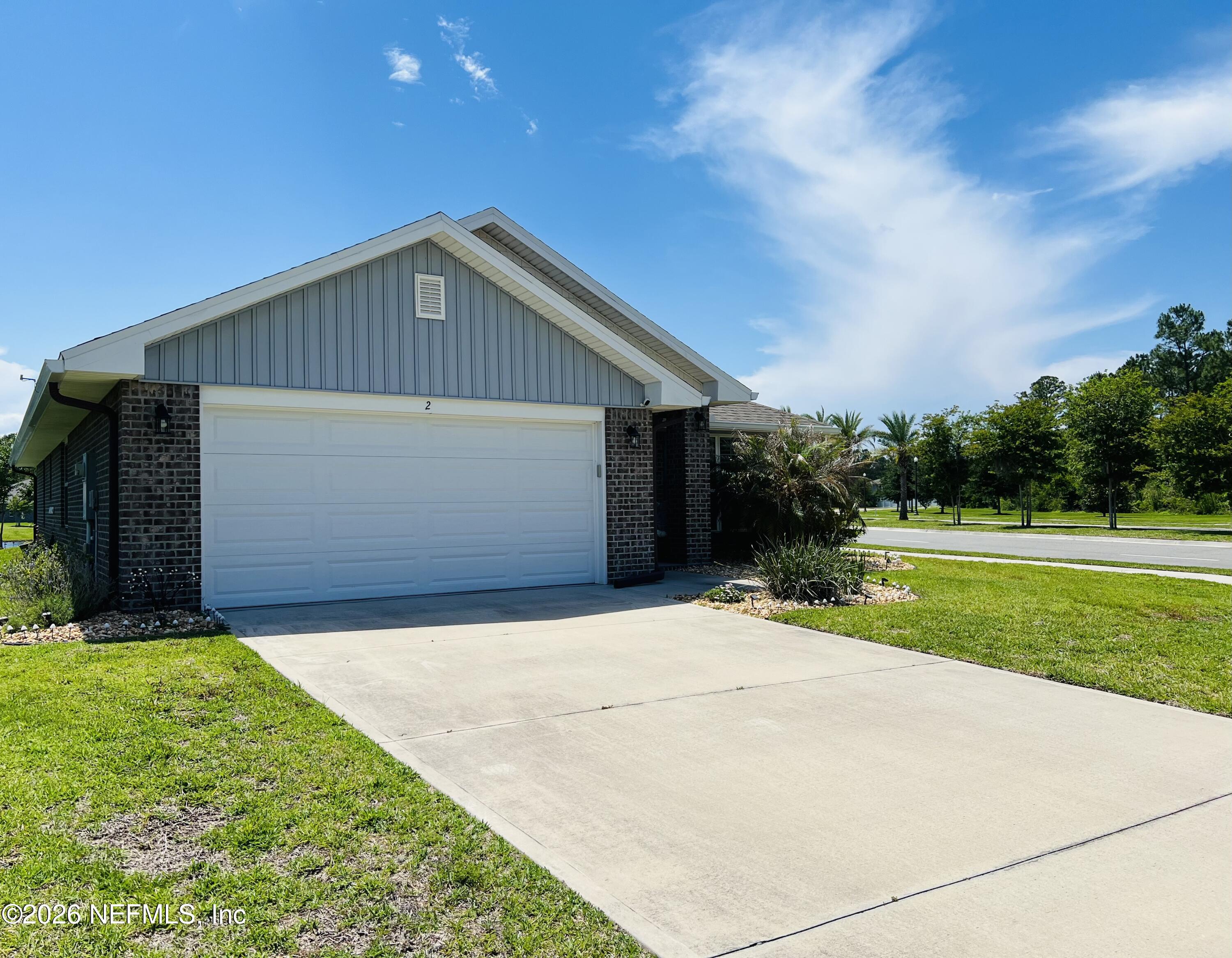 2 Rivertown Road Palm Coast, FL 32137 - Photo 2 of 80 a front view of house with yard and green space