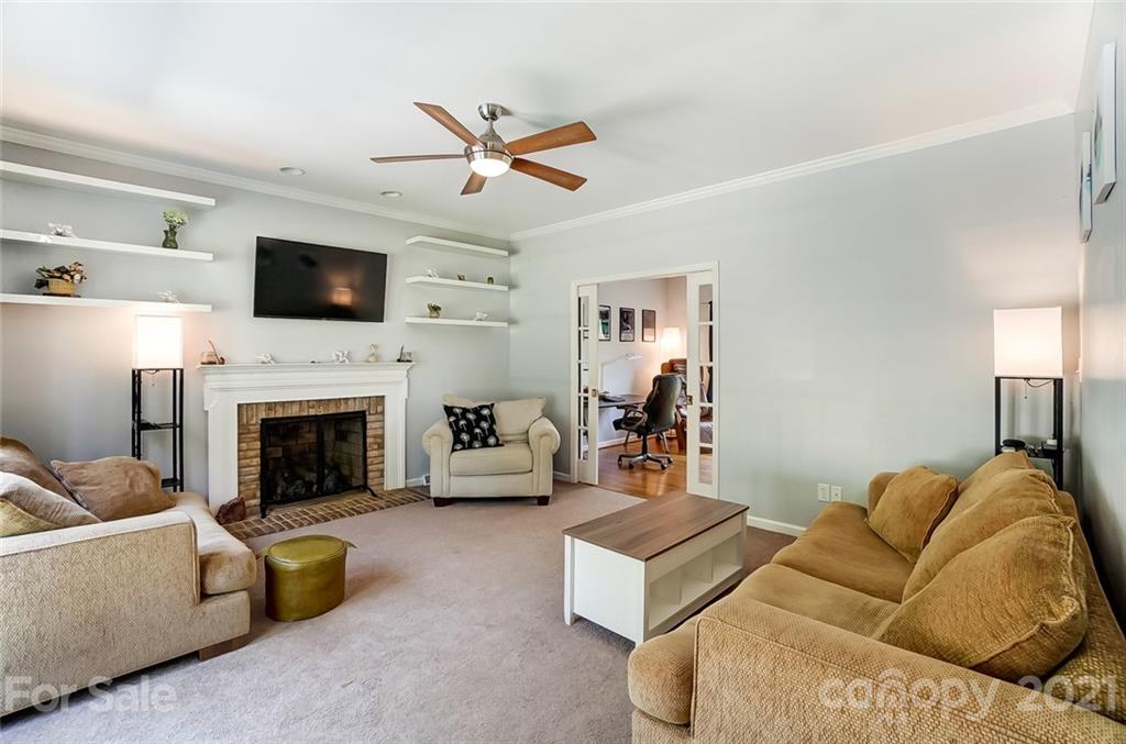 1999 Steeplechase Drive Rock Hill, SC 29732 - Photo 13 of 34 a living room with furniture a flat screen tv and a fireplace