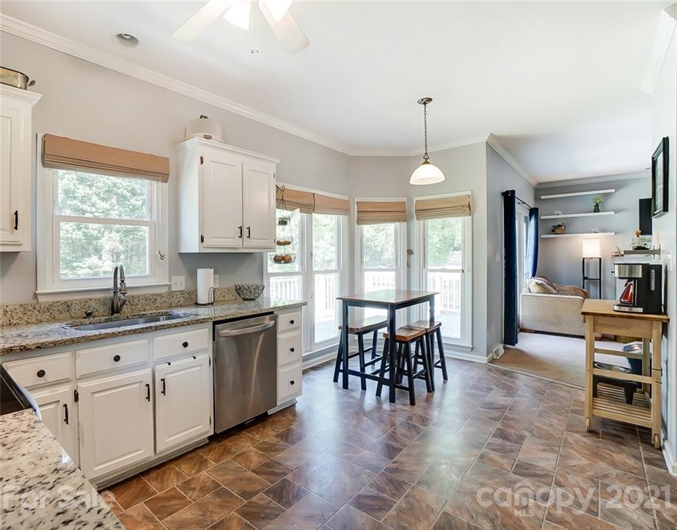 1999 Steeplechase Drive Rock Hill, SC 29732 - Photo 18 of 34 a kitchen with granite countertop a stove a sink a dining table and chairs