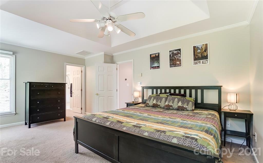1999 Steeplechase Drive Rock Hill, SC 29732 - Photo 23 of 34 a bedroom with a large bed and a chandelier