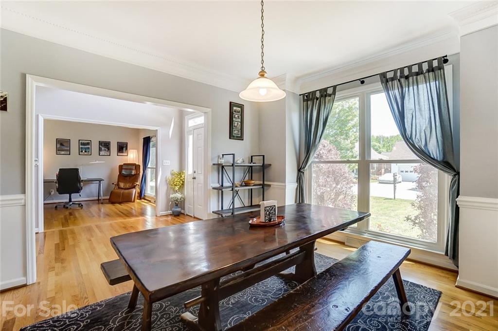 1999 Steeplechase Drive Rock Hill, SC 29732 - Photo 7 of 34 a dining room with wooden floor a chandelier a wooden table and chairs
