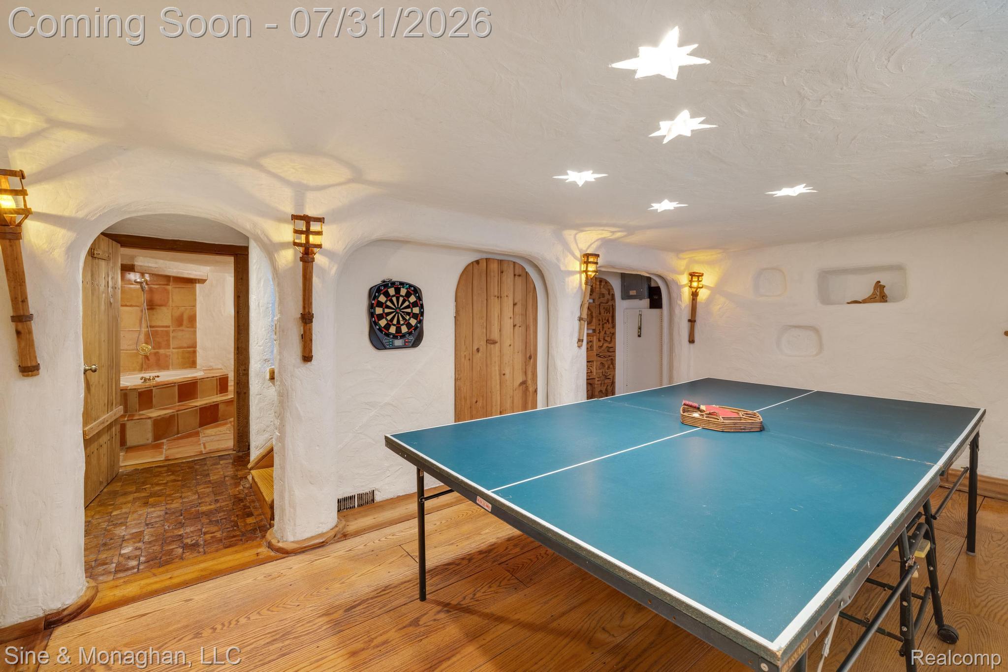 417 Cloverly Road Grosse Pointe, MI 48236 - Photo 42 of 70 Recreational space with wood-finish flooring, white textured walls, and star-shaped ceiling lighting