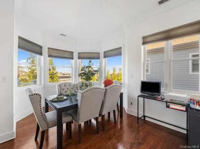 a view of a dining room with furniture and a window