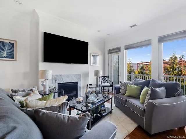a living room with furniture a fireplace and a flat screen tv