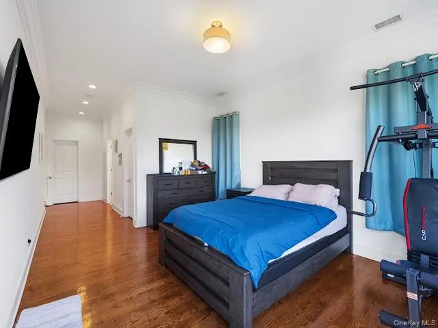 a bedroom with a bed and a flat screen television